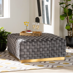 LUXE AND GLAM GREY VELVET FABRIC UPHOLSTERED AND GOLD FINISHED SQUARE COCKTAIL OTTOMAN